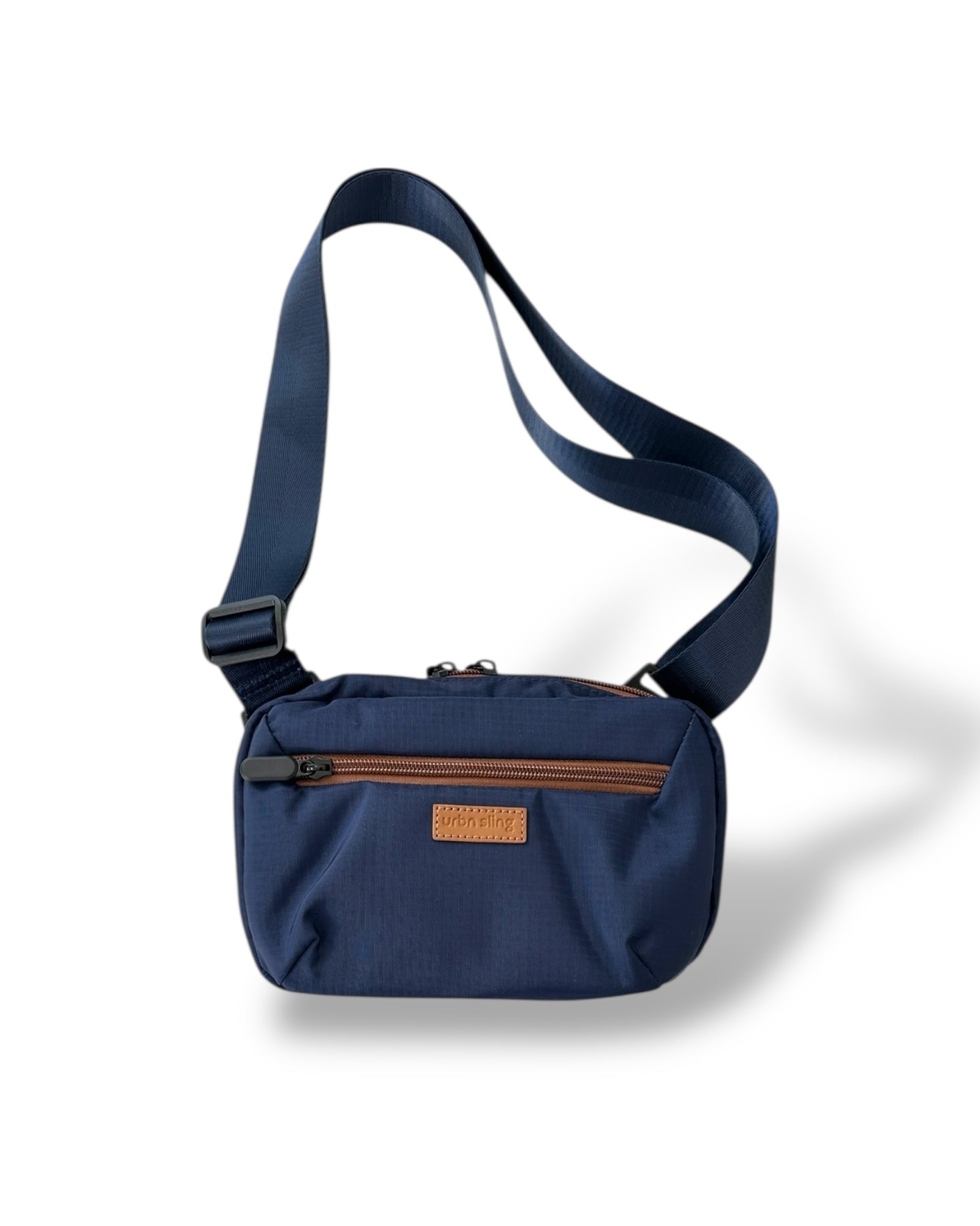 Everyday Sling cross body bag in navy blue textured fabric with strap
